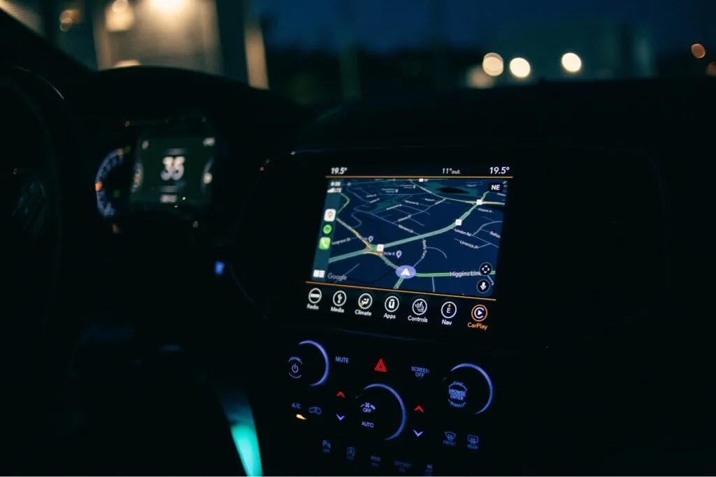 Identifying Issues With Your Current GPS Tracking System 4 A car interior featuring a GPS tracking system with a navigation display showing a map. The dashboard controls are visible, while the speedometer is partially illuminated in low light conditions.